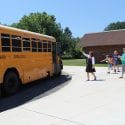 Teachers and students wave goodbye to each other