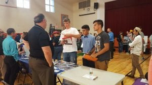 Students Speak with college representatives at College Caravan in the gym