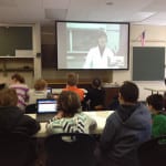 Students watch interactive lesson