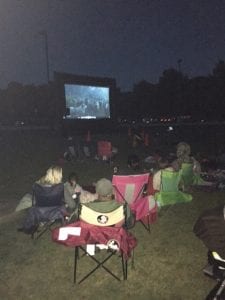 movie screen at WBH at night with people watching movie