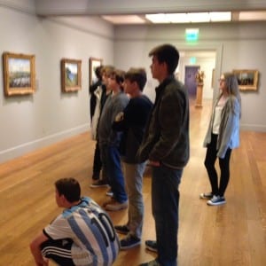 Photo of students looking at art