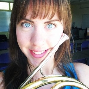 Photo of Miller holding a instrument