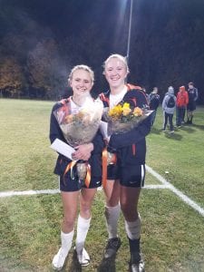 Feahters & O'Brien holding flowers after their last soccer game