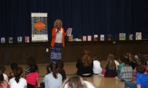 Photo of author coleen paratore speaking at assembly