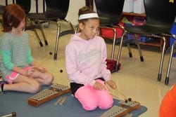 Elementary student plays xylophone