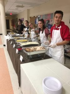 Students serving food at dinner
