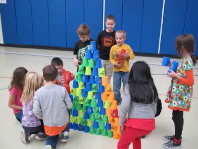 Elementary students stack cups
